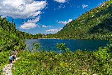 People trekking around Morskie Oko, the largest lake in the Tatra Mountains in Zakopane, Poland © momo11353