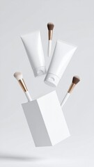Arrangement of Cosmetic Tubes Brushes and a White Box Against Neutral Backdrop