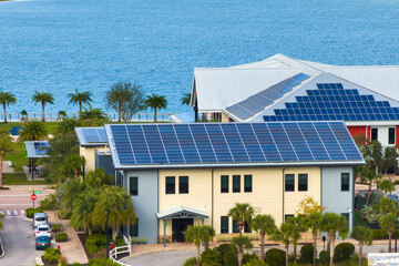 Autonomous buildings in Florida with photovoltaic rooftops covered with solar panels for producing...