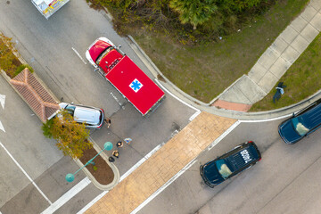 Car crash with first responders helping at accident site on American street. Vehicle collision on...