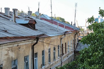 Old residential building with wires and antennas in urban area