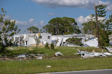Heavily damaged by hurricane houses in Florida mobile home residential area. Consequences of...
