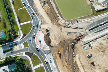 Industrial construction roadworks at roundabout intersection with moving cars in Venice, Florida....
