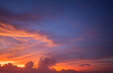 Sunset sky with bright colorful orange and yellow clouds. Panoramic skyscape