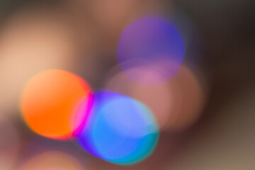 Abstract blurred lights in vibrant colors, creating bokeh effect. Mix of red, orange, purple and...