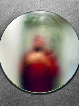 Blurred reflection of a man in a steamed up bathroom mirror