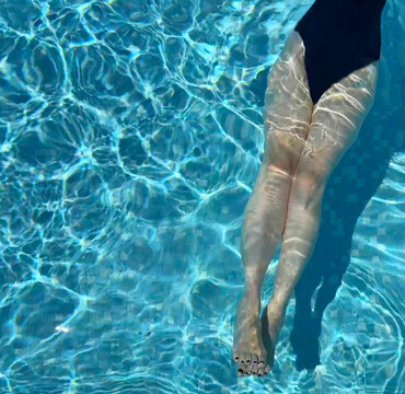 Overhead view of a woman's legs in a  swimming pool