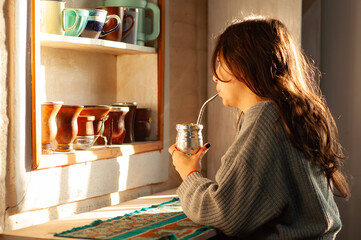 mujer bebiendo mate en la mañana. joven disfrutando un mate en la mañana.