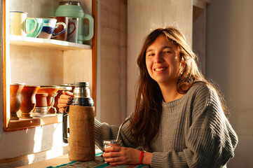mujer bebiendo mate en la mañana. joven disfrutando un mate en la mañana.