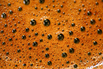 Extreme close up of espresso coffee foam as background