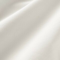 Soft white fabric draped elegantly on a surface showcasing its gentle texture and smooth appearance in natural lighting.
