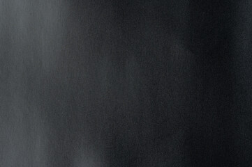 Smooth, paper textured dark surface illustrating minimalism and modern design concepts