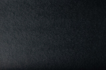 Black paper textured surface ideal for artistic and design endeavors