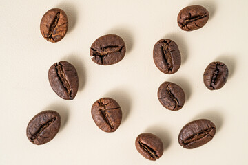 Flat lay of roasted coffee beans scattered on a surface.