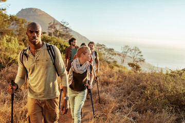 Young and diverse group of friends and hikers hiking together in the mountains of south africa