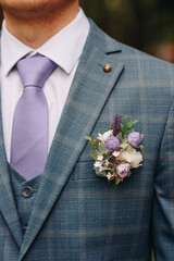 purple boutonniere on groom jacket