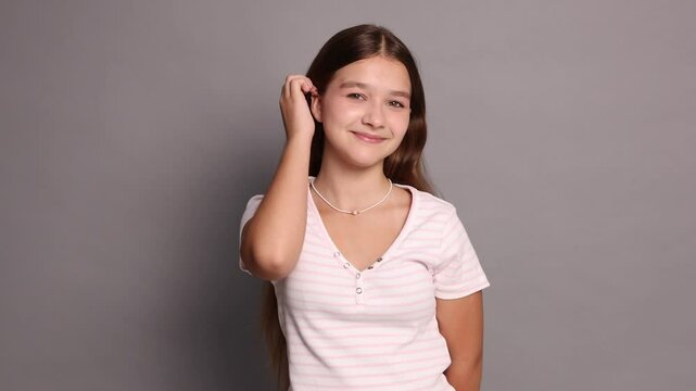Teenage girl in casual clothes on grey background
