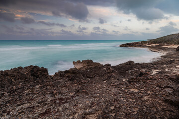 Sunset on the sandy beach of the Atlantic Ocean.