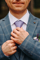 groom portrait, hands on purple tie