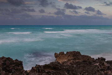 Sunset on the sandy beach of the Atlantic Ocean.