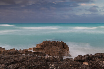 Sunset on the sandy beach of the Atlantic Ocean.