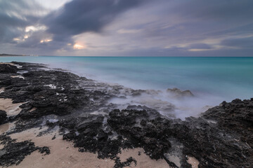 Sunset on the sandy beach of the Atlantic Ocean.