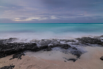 Sunset on the sandy beach of the Atlantic Ocean.