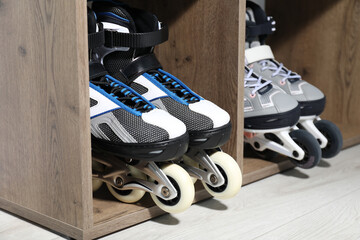 Pairs of roller skates in shelving unit, closeup