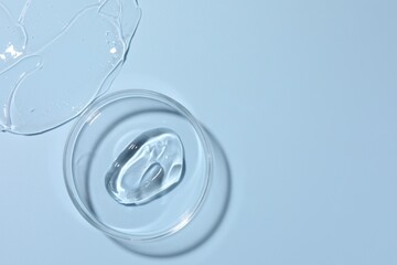 Cosmetic product in Petri dish on light blue background, top view. Space for text