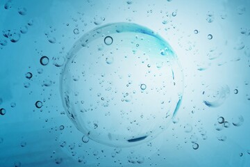 Hyaluronic acid gel or serum texture. Abstract blue liquid background with bubbles. Skincare,...