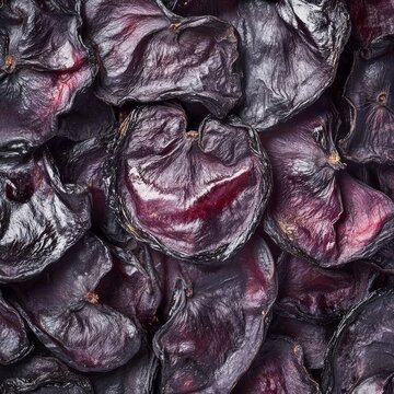 closeup of dried kokum slices with dark purple skin and wrinkled texture macro food photography clean isolated