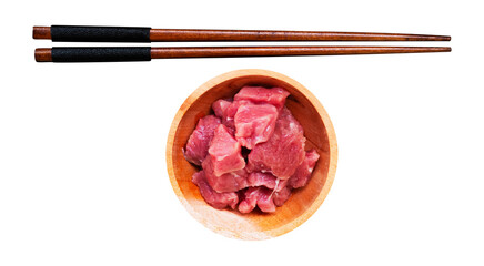 wooden chopsticks and raw meat in a wooden bowl with a white isolated background