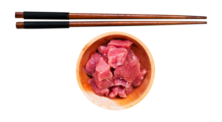 wooden chopsticks and raw meat in a wooden bowl with a white isolated background
