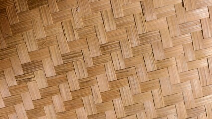 Close-up of handwoven natural bamboo mat, showcasing its intricate textures and craftsmanship, A delicate pattern of interwoven strips of dried bamboo provides a warm and organic visual