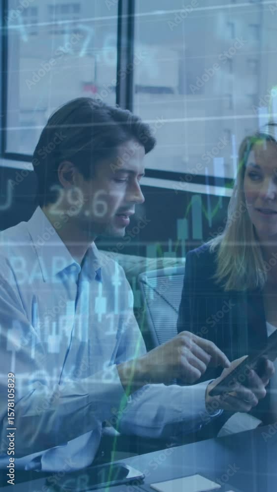 Aufkleber animation of trading board and graphs over diverse coworkers discussing reports on desktop in office