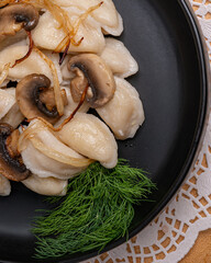 Traditional dumplings with mushrooms and herbs on plate