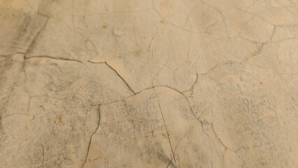 Cracked Beige Wall: Imperfect Surface Texture, Subtle Light and Shadow Play on an Aged Plaster Wall