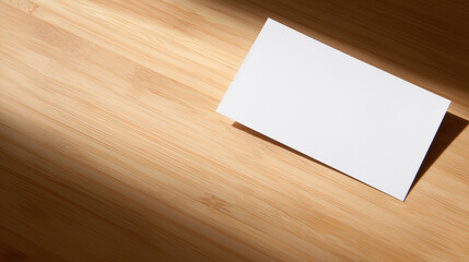 A blank notecard on light wood, embodying simplicity and natural beauty.