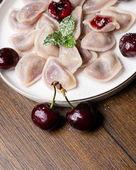 Sweet dumplings on a plate with fresh fruit