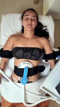 Patient receiving emsculpt neo treatment, a non-invasive body contouring procedure using radiofrequency and high-intensity focused electromagnetic energy