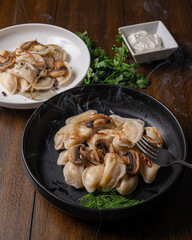 Fork with dumpling over rustic dinner table
