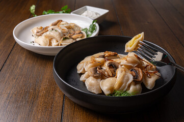 Fork with dumpling over rustic dinner table