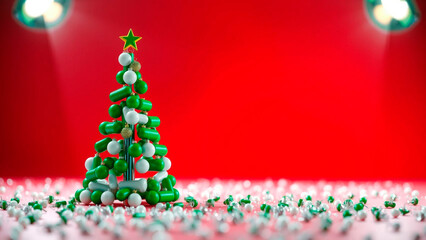 Christmas tree made of green and white pills with a star on top against a red background with lights