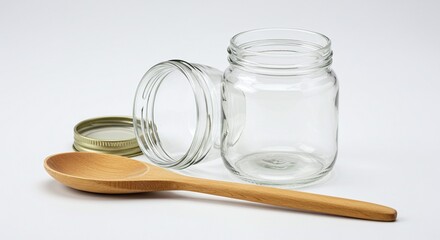 Empty Glass Jar with Wooden Spoon and Metal Lid on White Background