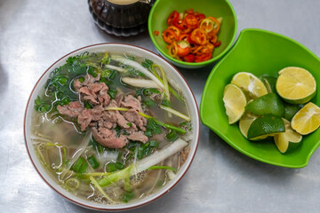 Vietnam traditional pho, Beef noodles. Pho Bo Soup with beef, rice noodles, ginger, lime, chili...