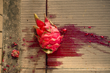 top view smashed red-fleshed dragon fruit on the ground