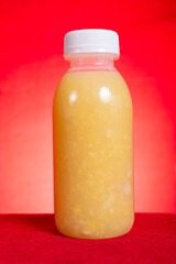 homemade bottle of mung bean water chestnut beverage on red background at vertical composition