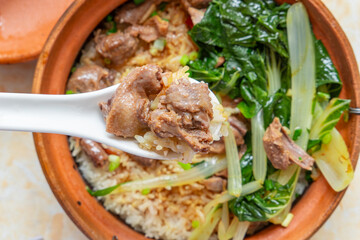 top view claypot rice with marinated squab at horizontal composition