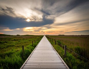 Wooden path leading to sunset