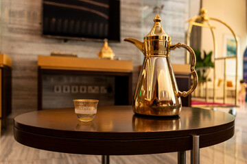 White background. Ramadan concept. Still life with traditional golden arabic coffee set with dallah and cup.